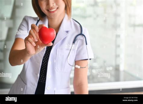 Cardiac Center Concept Doctor Women Smile And Holding A Red Heart