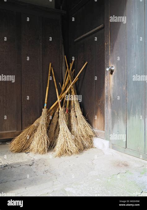 Wooden Brooms Leaning On Wall At Temple Stock Photo Alamy
