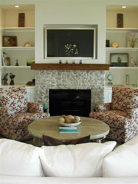 In this living room, not just the television but the tv wall panel itself is backlit. fireplaces with tv above, white built-ins are simple ...