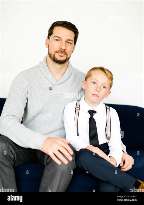Well Dressed Father And Son Sitting On Sofa Stock Photo Alamy
