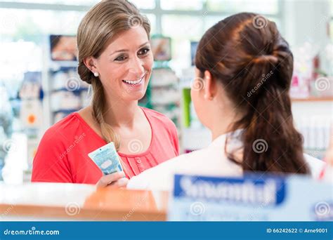 Woman In Pharmacy Being Counseled By Sales Lady Stock Photo Image Of
