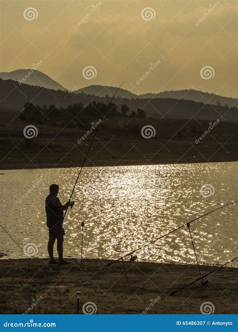 Fisherman Fishing At Sunset Stock Image Image Of Angling Fighting