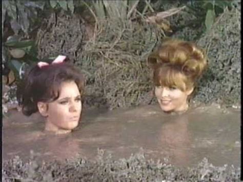 Two Women Are In The Water With Their Hair Pulled Back