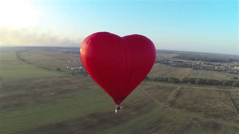 Red Hot Air Balloon In The Shape Of A Heart In The Air View Around