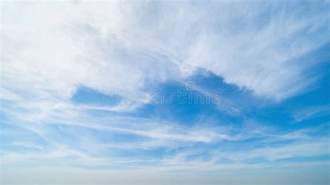 Clear Blue Sky With White Fluffy Clouds In Summer Season At Noon Time
