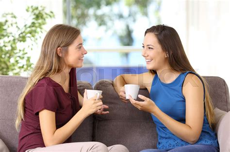 Two Girls Talking And Drinking At Home Stock Image Colourbox