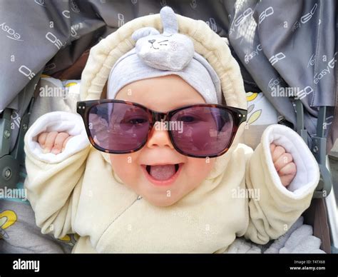 Funny Face Of Baby Girl Is Laughing In Sunglasses Cute Baby With