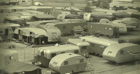 An Old Black And White Photo Of Many Trailers Parked In A Parking Lot