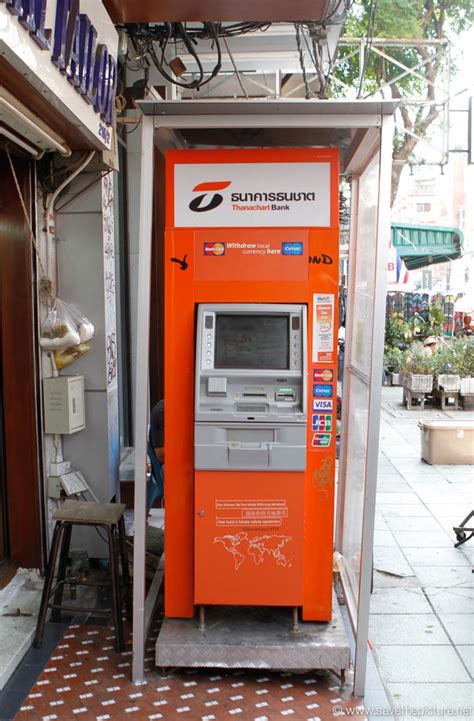 Atm withdrawals require a debit or credit card and a pin. Thailand Bangkok ATM Machine Thanachart bank orange ...