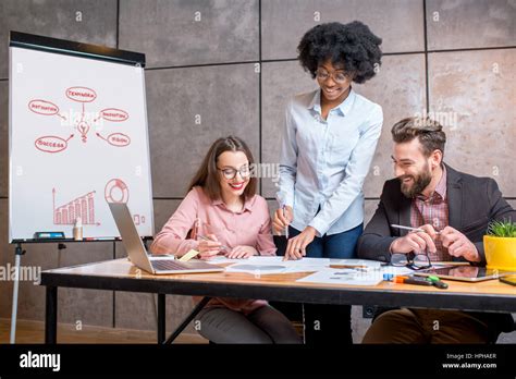 Coworkers Working Together Indoors Stock Photo Alamy
