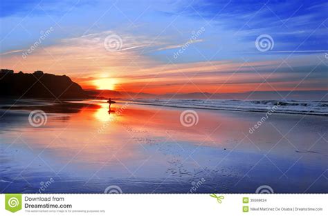 Surfer In Beach At Sunset With Reflections Stock Photo Image Of