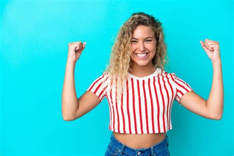 Premium Photo Girl With Curly Hair Isolated On Blue Background Doing Strong Gesture