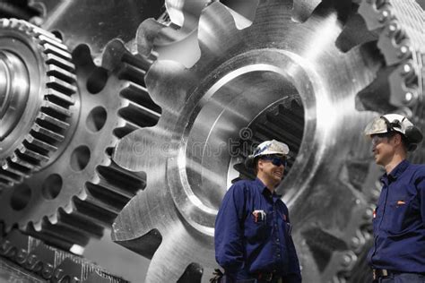 Engineers Examining Large Gears And Cog Machinery Stock Photo Image
