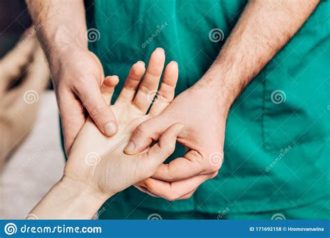 wrist massage a male massage therapist puts pressure on a sensitive point on a womans hand