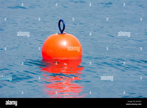 Orange Buoy Floating In Blue Water Stock Photo Alamy