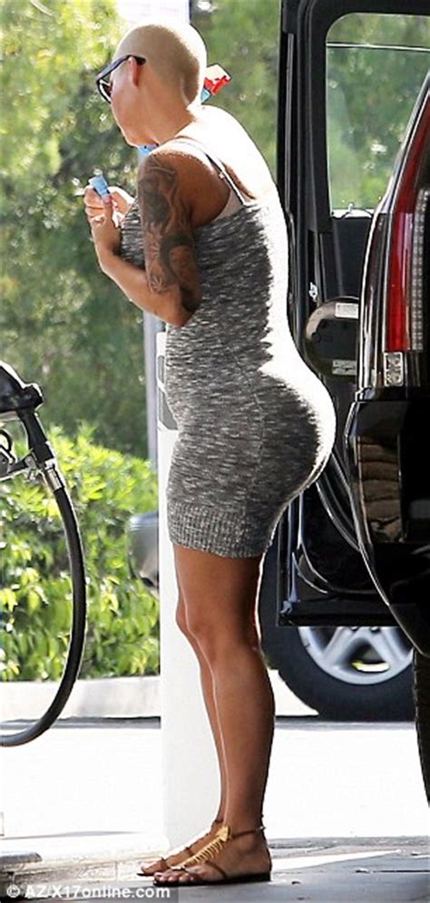 Amber Rose Puts On A Sensual Display As She Slips Her Curves Into Form Fitted Grey Mini Dress