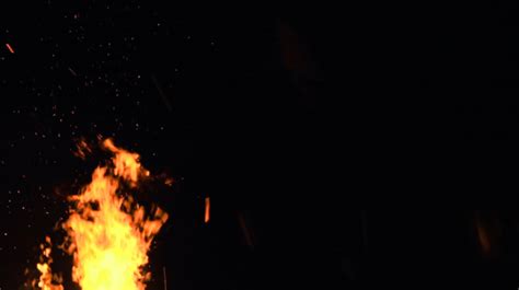 Ultra Slow Motion Shot Of Fire Flames And Glowing Ashes On Black