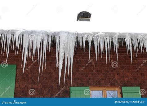 Many Large Dangerous Icicles On A House Roof In Winter Stock Image