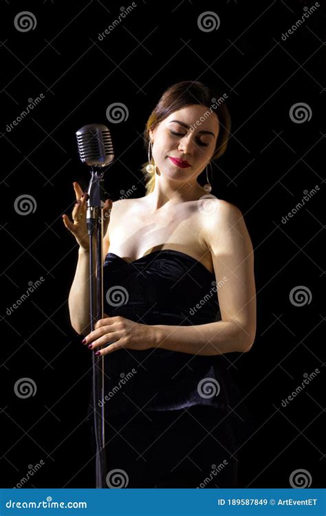beautiful woman singing on vintage microphone on black background stock image image of