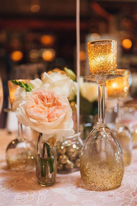There Are Three Wine Glasses On The Table With Flowers And Candles In