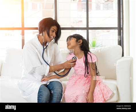 Indian Female Doctor Treating Young Patient Stock Photo Alamy