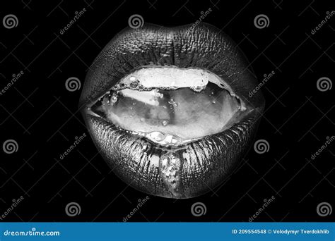 saliva in the mouth female open mouth with lips and teeth closeup on black background stock