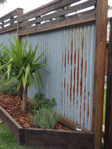 Corrugated steel fencing is a popular new trend that we are excited to offer to our clients. Recycled hardwood timber fence, I dreamed of this for a long time. Rusty corrugated iron. Timber ...