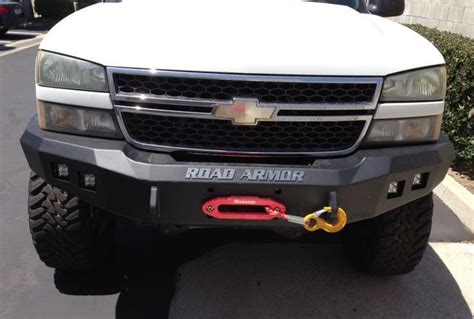 The Front End Of A White Truck Parked In A Parking Lot