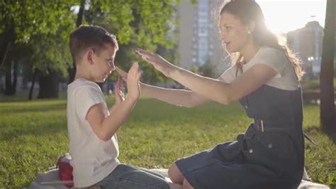 Older Sister Spending Time With Younger Brother Outdoors Stock Footage