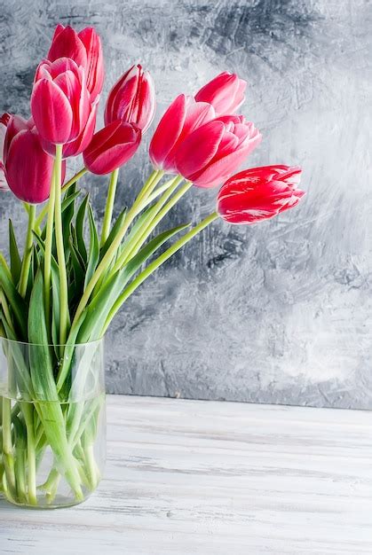 Premium Photo Bouquet Of Pink Tulips In A Glass Vase On Grey Background