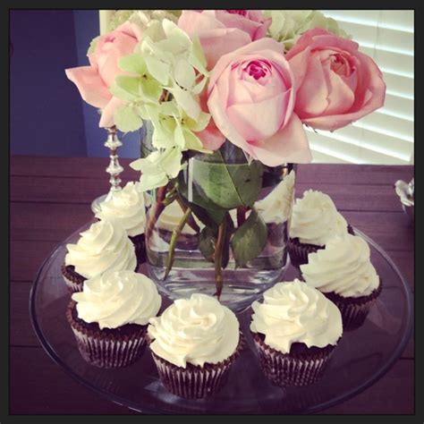 Center Piece Of Roses And Hydrangeas Surrounded By Yummy Cupcakes