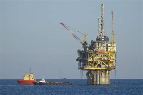 Spar Type Oil Platform With Supply Vessels Photograph By Bradford