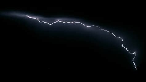 View Lightning Bolts Flash Across A Black Night Sky By Dustin Farrell