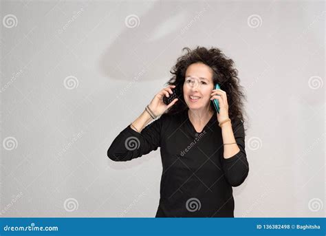 Woman Over Holding Two Phones To Her Ears Stock Photo Image Of
