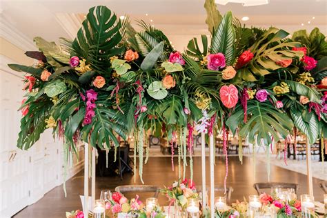 Tropical Garden Wedding Centerpiece With Palm Leaves And Fronds Wood Farm Tables And Crossb