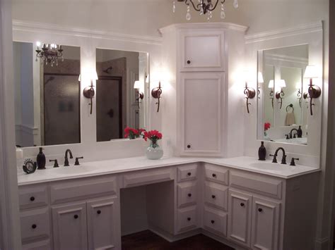 Double sink vanity is complete up of two single vanities, attached together in the central point with a counter tops table. custom cabinets/ corner linen tower/ vanity with split ...