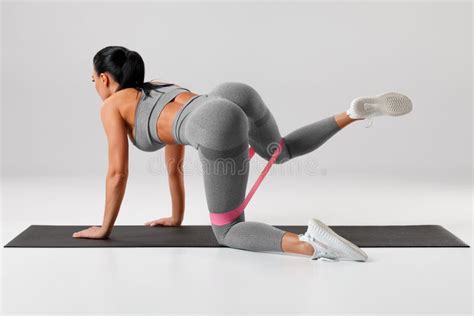 Fitness Woman Doing Exercise For Glutes Cable Kickbacks Athletic Girl Workout At The Gym Stock