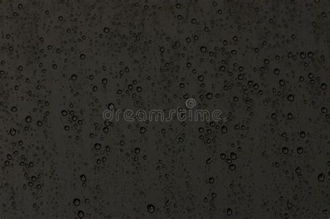 Focus And Blurred Photo Of Rain Drop On Glass Window With Dark Color