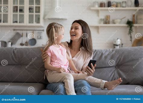 Cheerful Daughter Sitting On Mother Lap Enjoy Online Education Programs