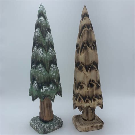 Two Small Wooden Trees Sitting Next To Each Other