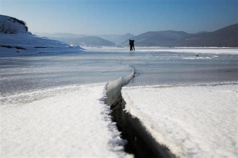Cracked Frozen Lake With Mountain On Frozen Lake Baikal In Winter