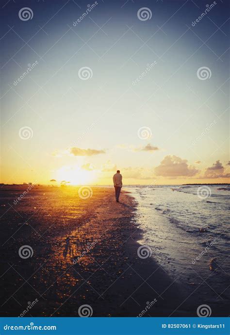 Lonely Man Walking On The Beach At Sunset Stock Image Image Of Person