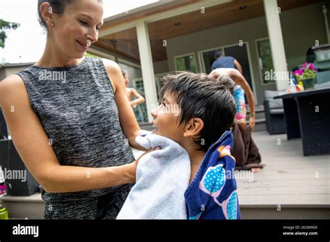Mother Drying Son With Towel In Backyard Stock Photo Alamy