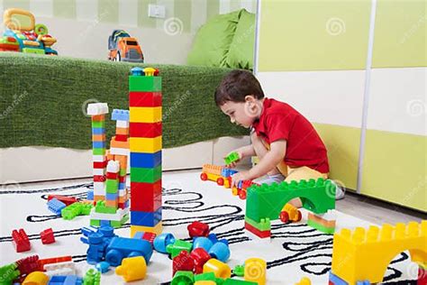 The Little Boy Who Build Towers With Plastic Cubes Stock Image Image