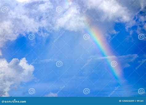 Real Rainbow On Blue Sky With Clouds Nature Background Stock Image