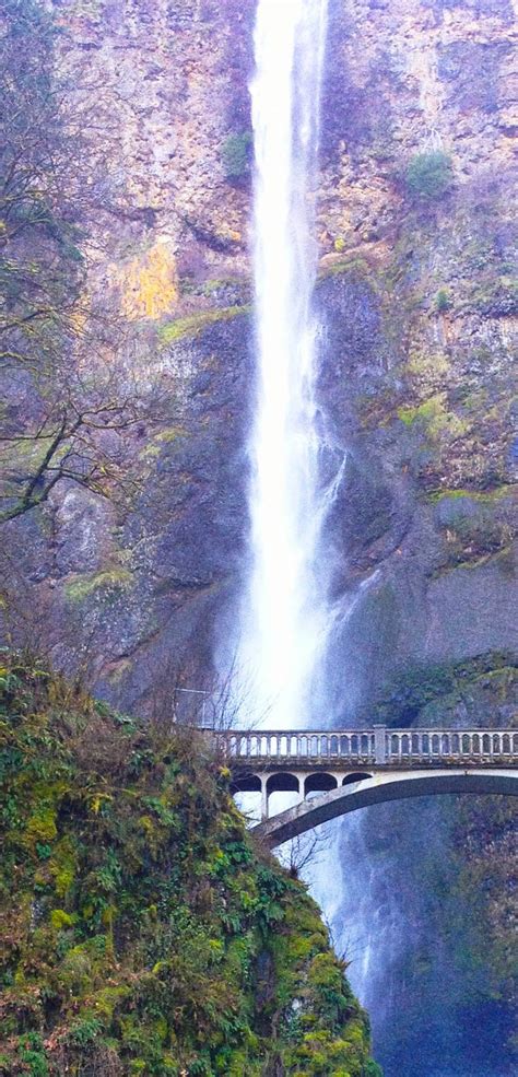 A Large Waterfall With A Bridge Over It