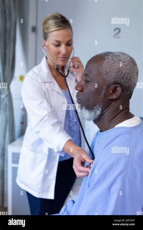 Caucasian Female Doctor Examining With Stethoscope African American