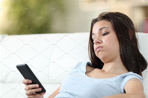 Bored Girl Checking Mobile Phone At Technology Stock Photos