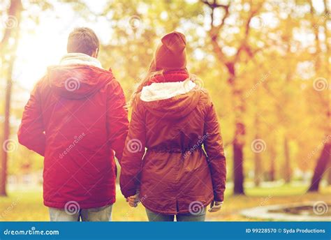 Happy Young Couple Walking In Autumn Park Stock Photo Image Of Autumn