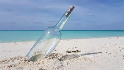 Bottle With A Letter On Sand On The Beach Stock Footage